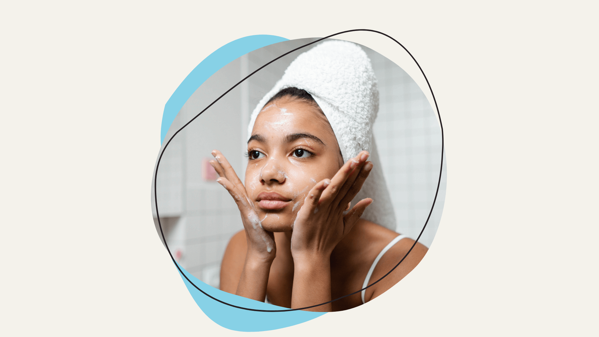 A young woman with a towel on her head washing her face.