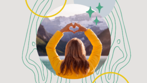 Young woman taking care of her mental health by a lake with her hands in the shape of a heart.